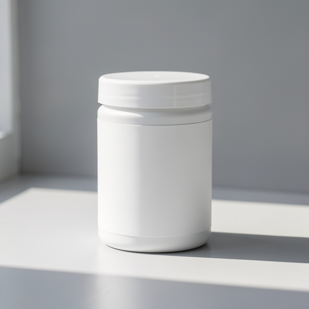 White supplement jar with clean label standing on a pale grey surface with natural window light casting a soft shadow